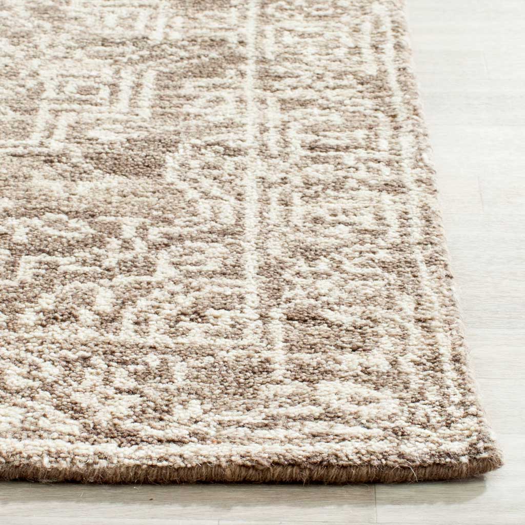 Textured brown and beige pile meets a neatly finished edge along the ornate border