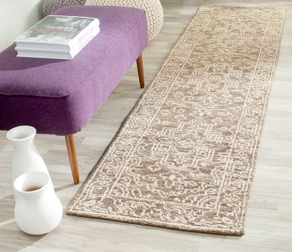 An ornate brown and beige runner brings warmth and intricate pattern to a narrow living space