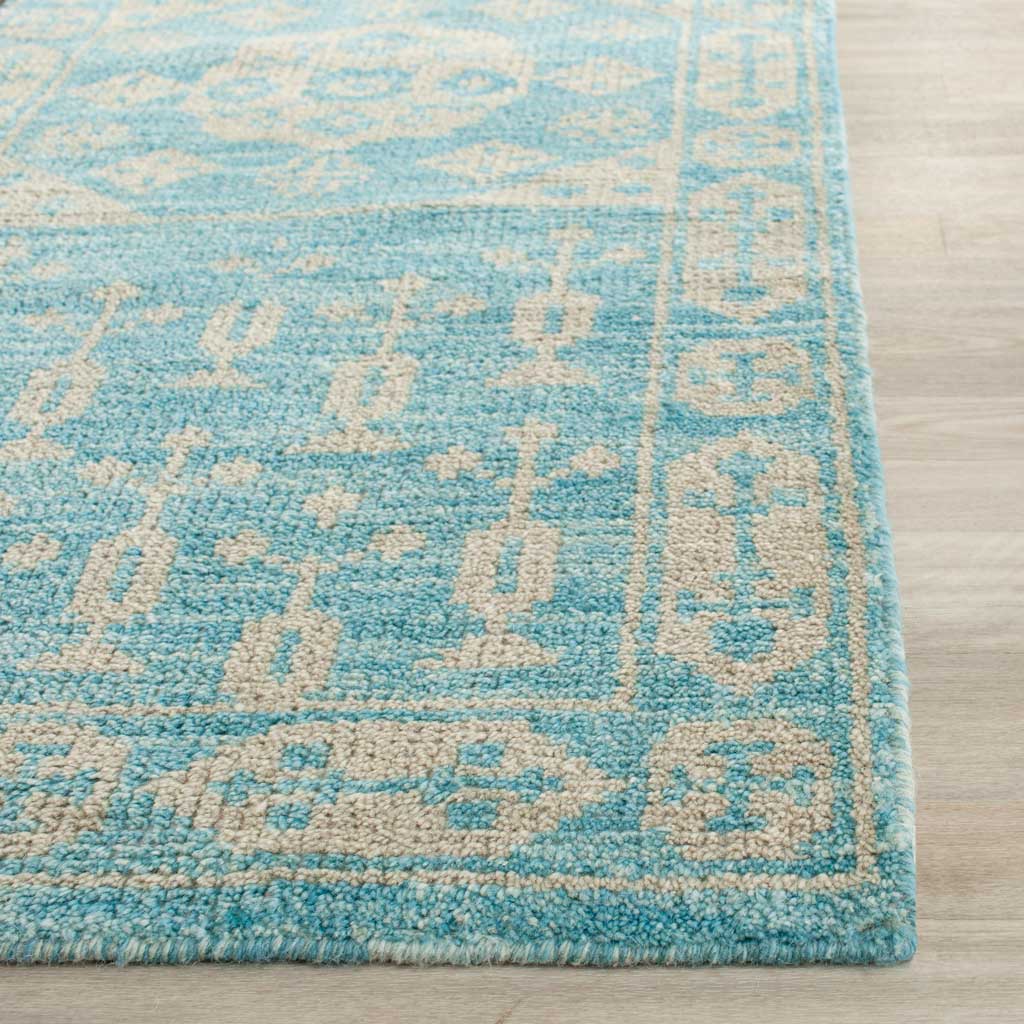 Textured blue and ivory pile highlights an intricate border and neatly finished edge