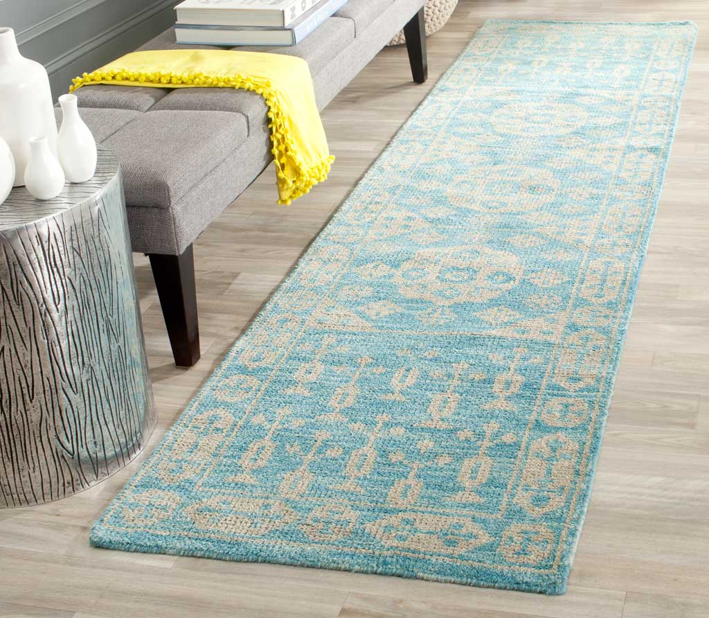 A traditional blue and ivory runner adds a soft patterned accent beside a seating area