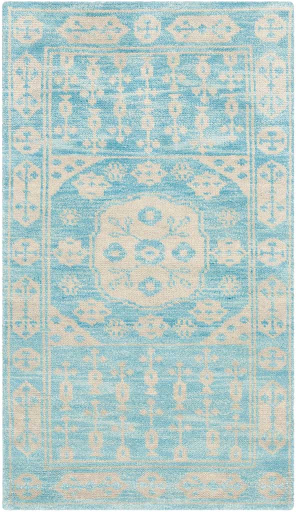 A sky-blue rug layers a cream medallion with delicate floral details and a patterned border.