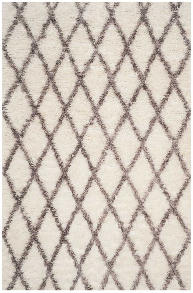 Plush ivory and soft gray fibers form a striking geometric lattice across this rug.