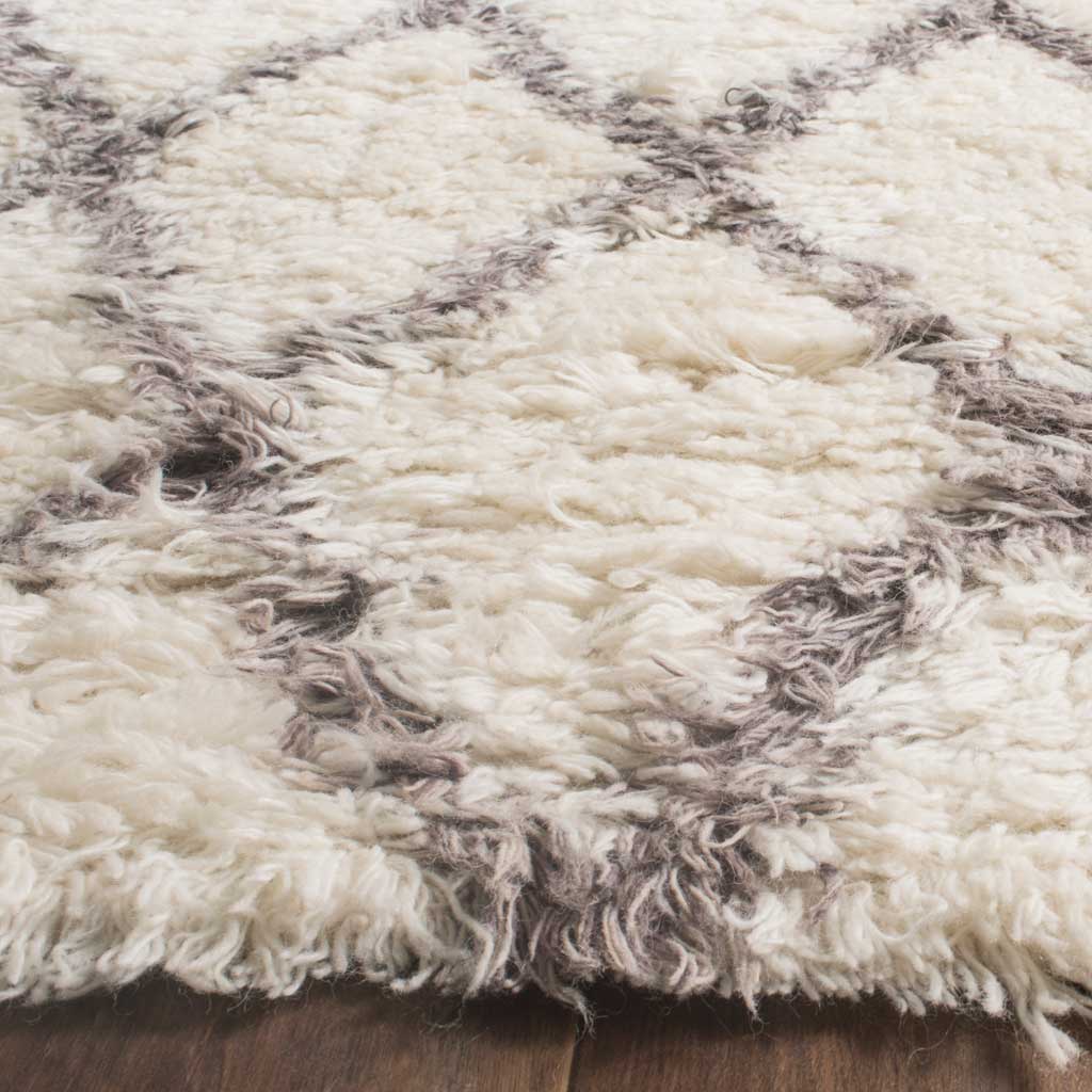 Thick ivory and gray fibers create a cozy, high-pile texture with a shaggy edge.
