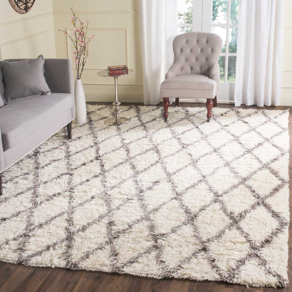 Soft ivory pile and gray diamonds anchor a seating area with a relaxed geometric design.