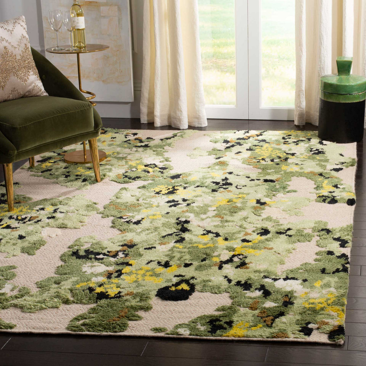 A plush green and beige rug with painterly black and yellow accents anchors a bright living space