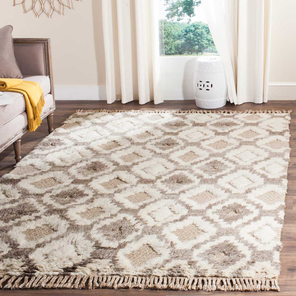 Plush cream and taupe motifs and fringed ends bring cozy texture to a living room