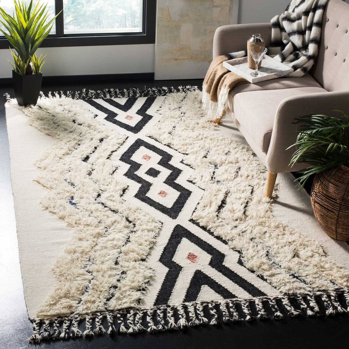 Raised ivory texture softens the bold black geometric design of this fringed rug