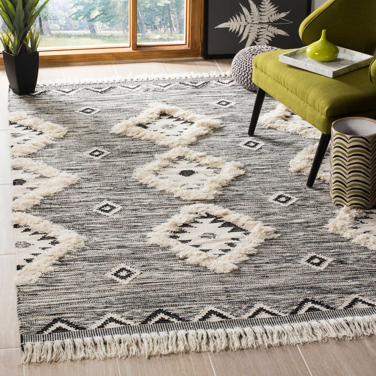 Black and ivory geometric rug adds plush diamond motifs and a fringed finish to a living area
