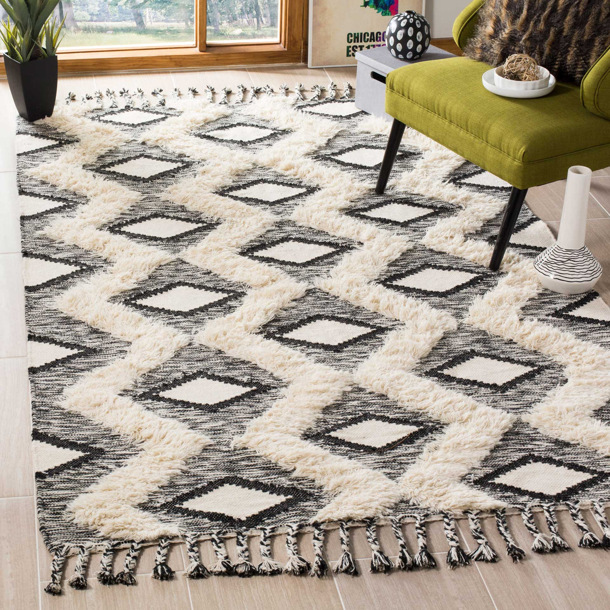 Graphic black diamonds and plush ivory bands warm the floor beside a green chair.