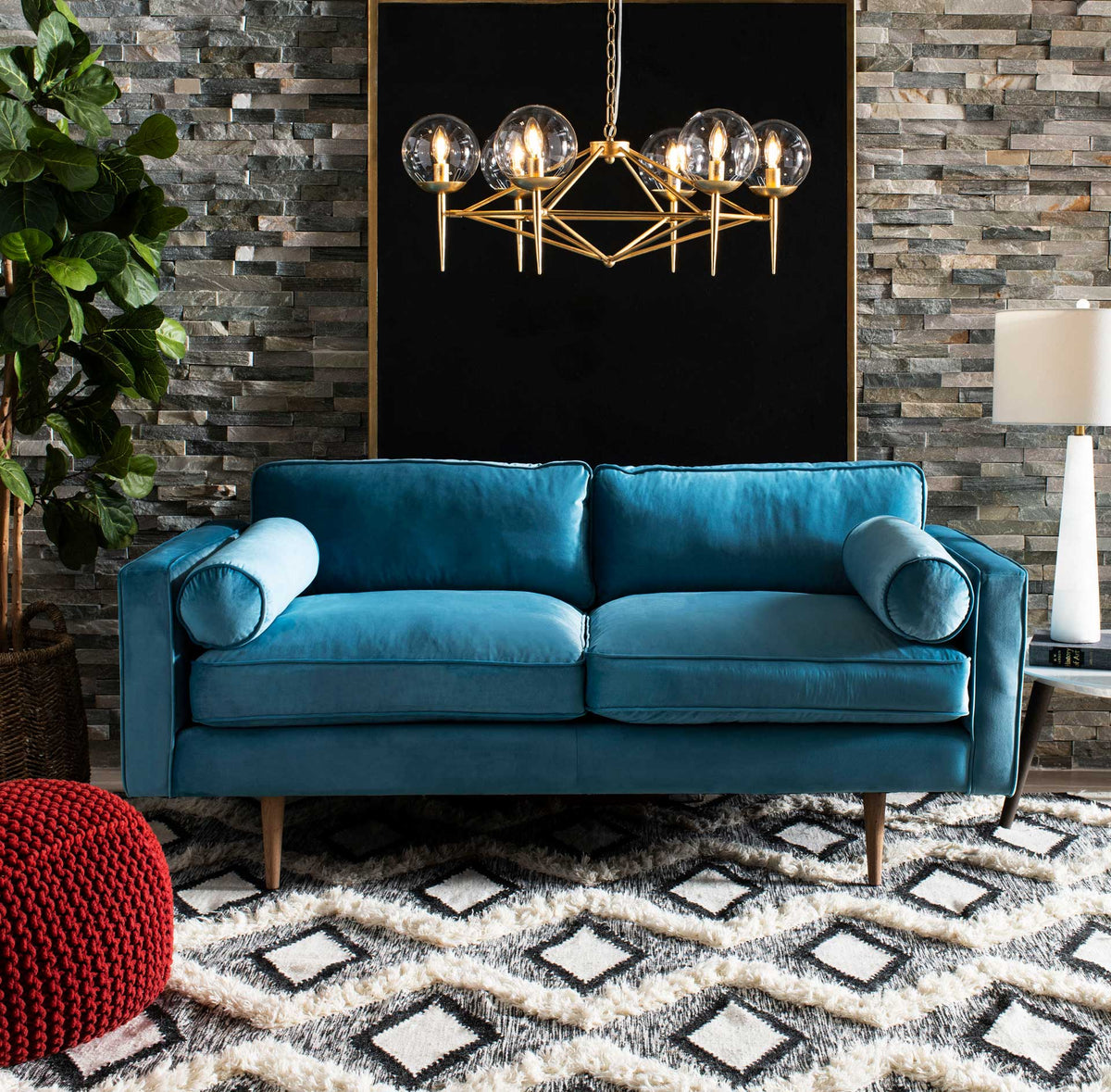 Plush ivory zigzags and black diamonds add striking texture beneath a teal sofa.