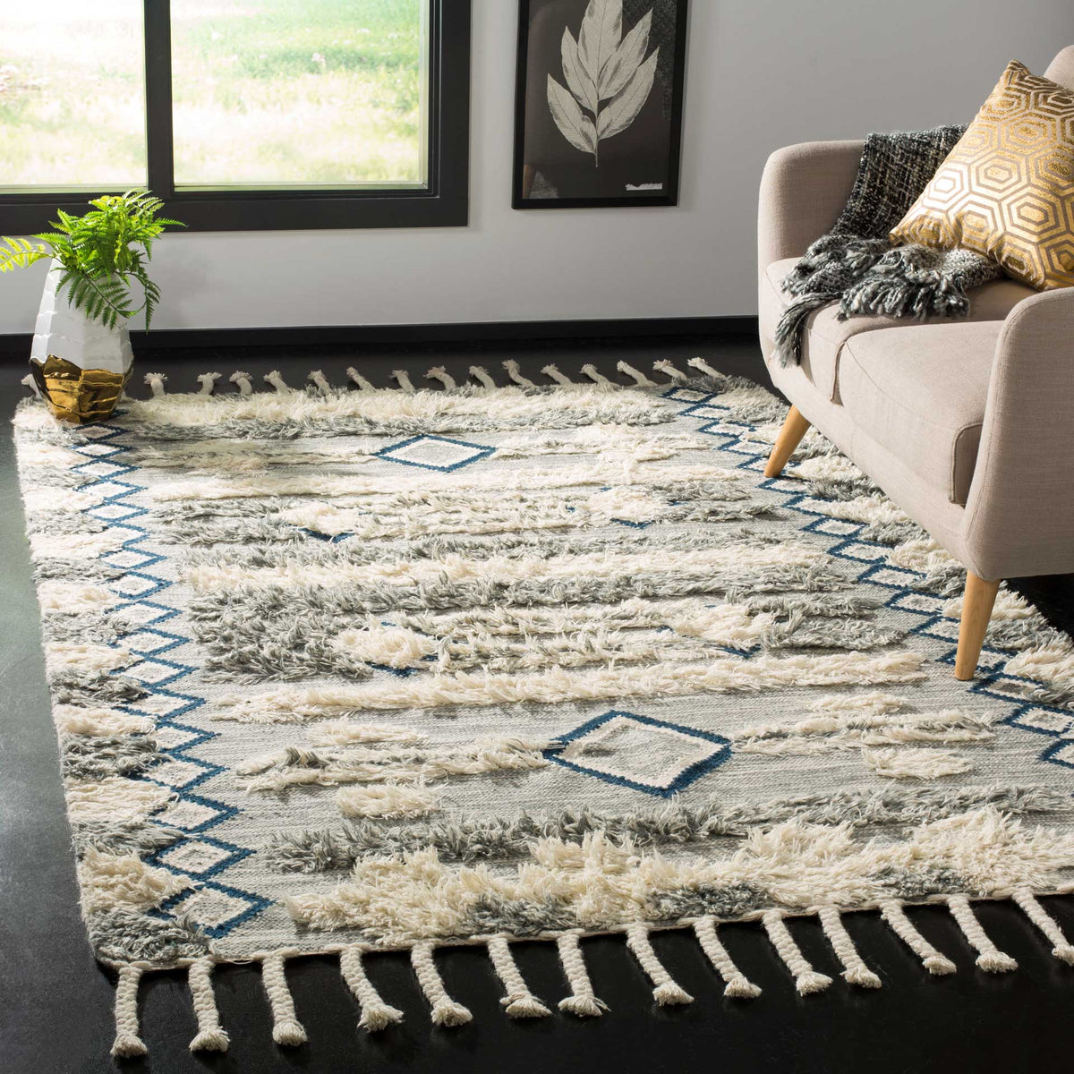 Blue diamond accents and tasseled ends bring warmth and texture to a gray and ivory living room rug