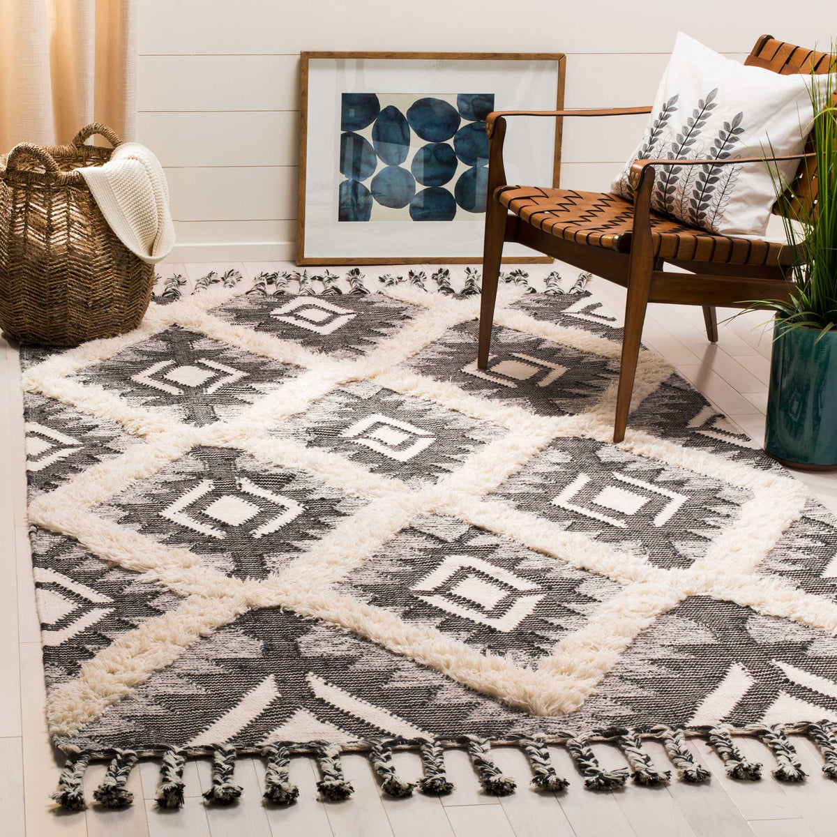 A black and ivory diamond rug brings soft texture and fringed detail to a cozy space