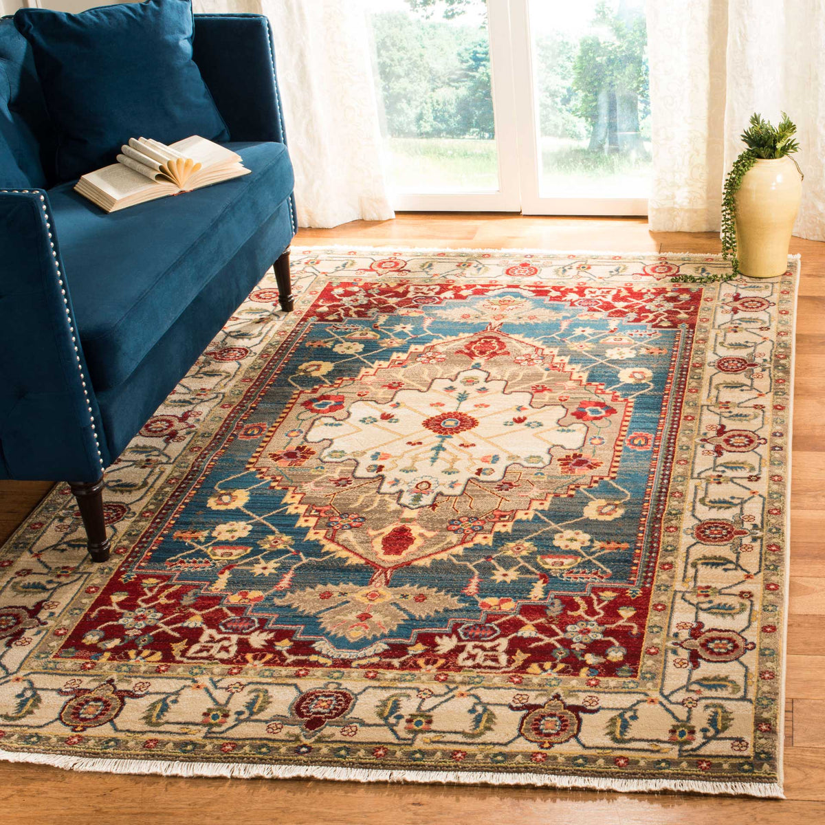 An ivory medallion, blue field and warm red accents bring traditional color to the living room