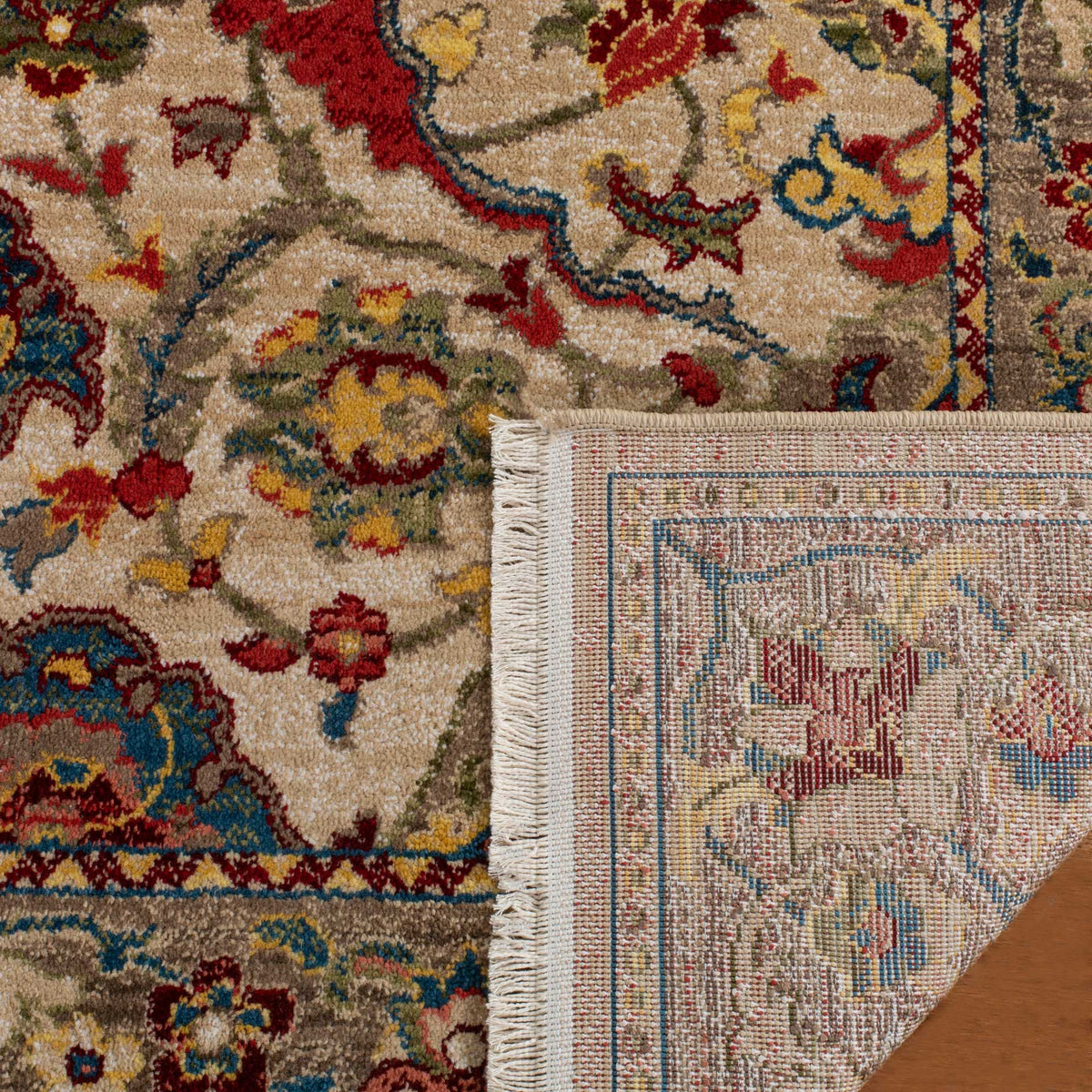 Woven backing and ivory fringe complement the rug's colorful floral pile.