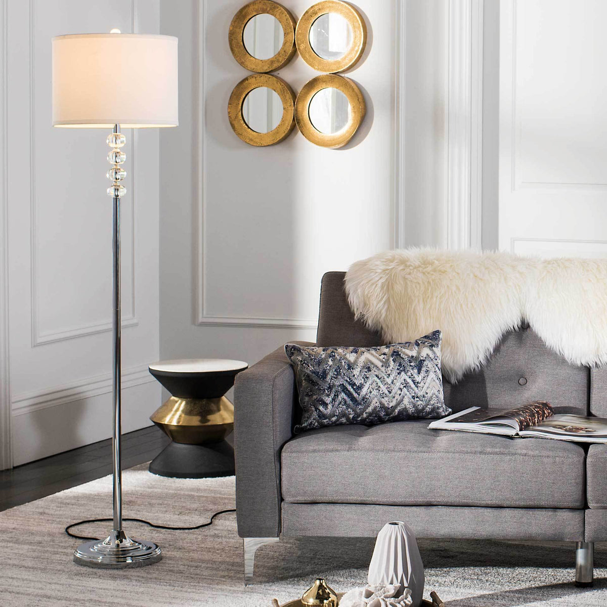 An illuminated off-white shade casts a warm glow above crystal accents and a polished chrome base