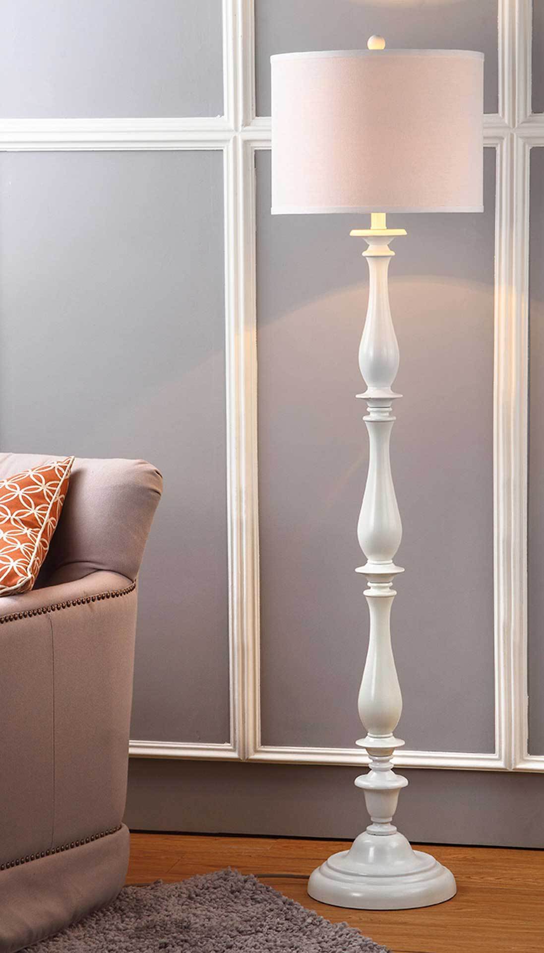 Glowing off-white shade casts warm light above an ornate white candlestick column