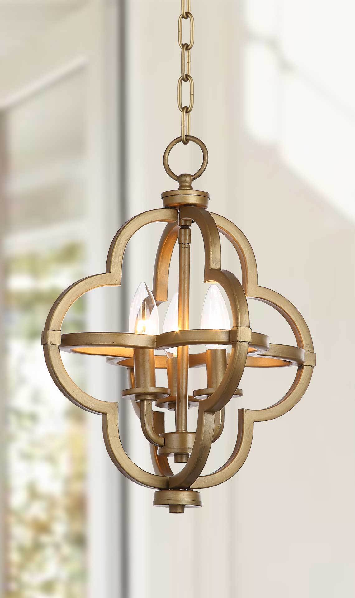 A warm glow highlights the sculptural quatrefoil frame and open metalwork of this pendant.
