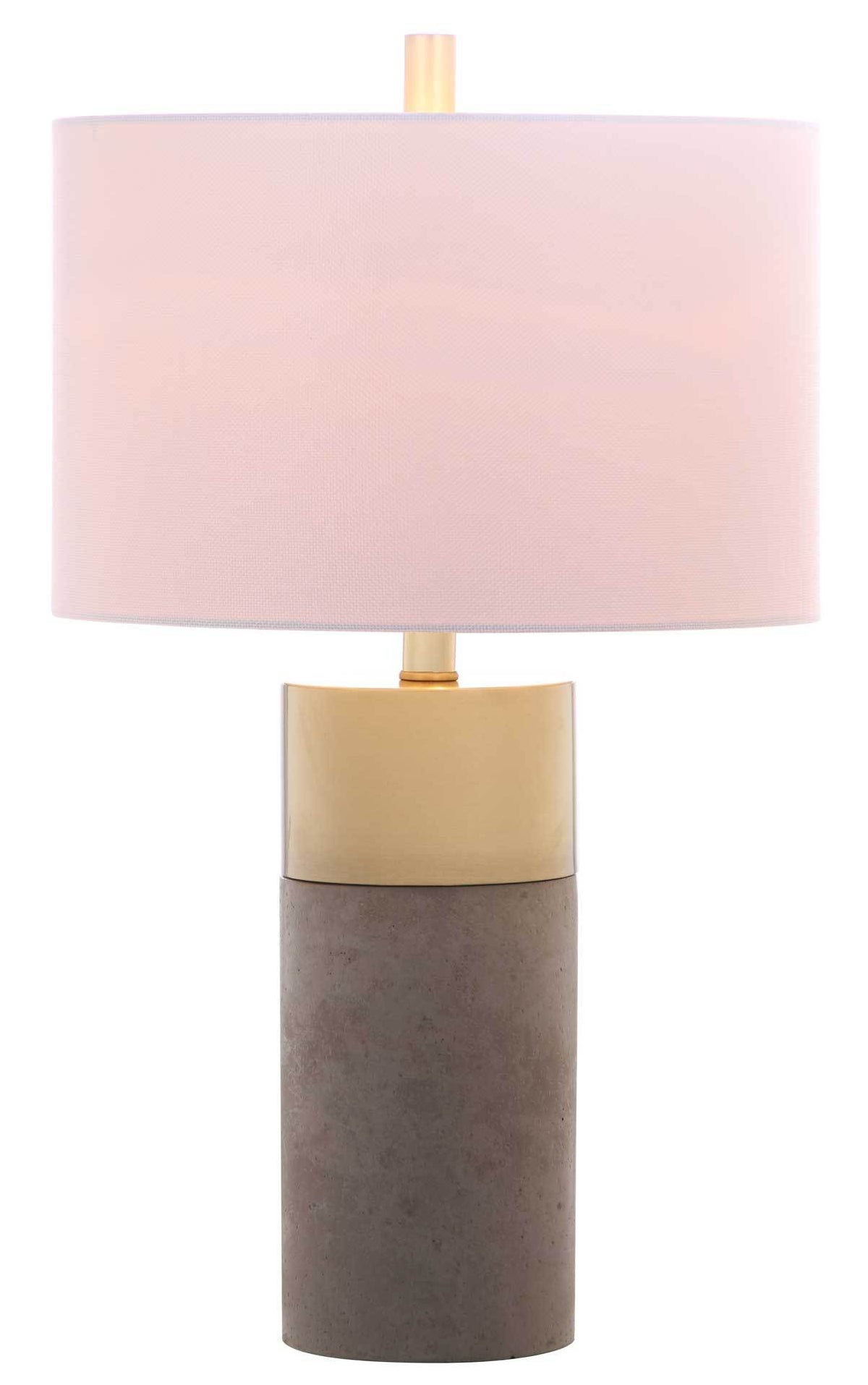 Soft light glows through a white drum shade above brass gold and gray concrete accents