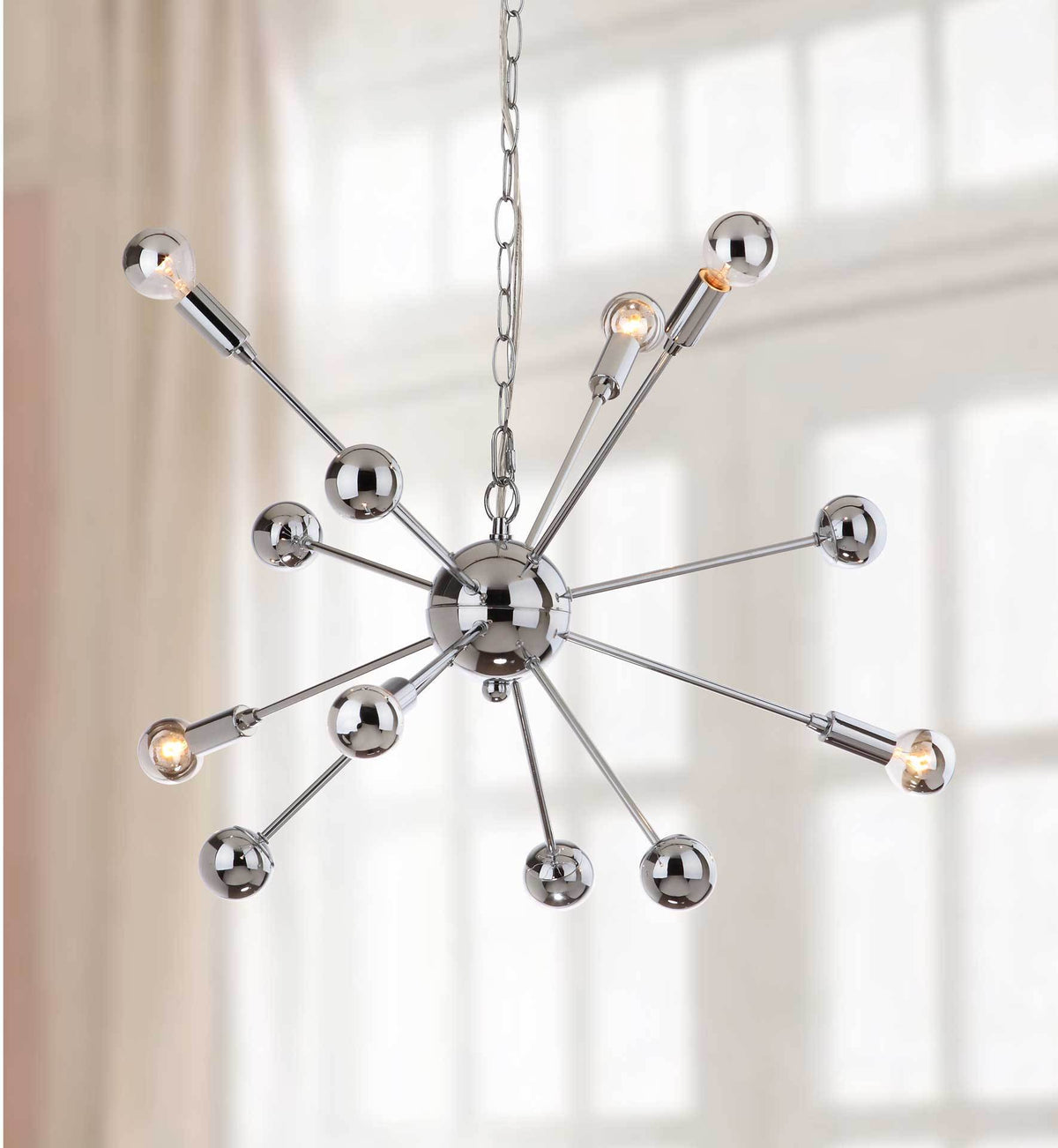 Warm bulbs illuminate the radiating chrome arms and gleaming spheres of this modern pendant.