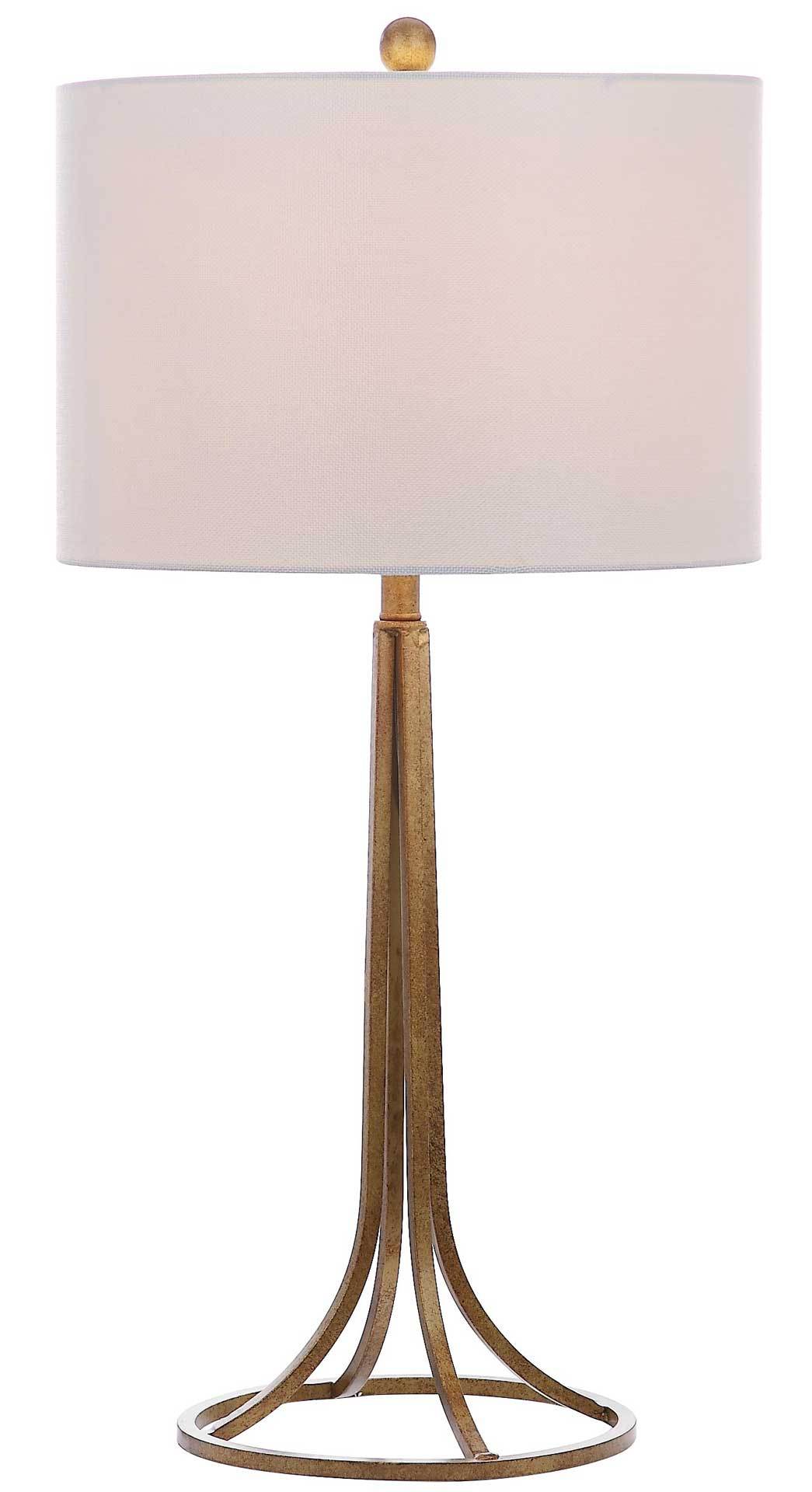 A warm glow fills the drum shade above a slender antique bronze frame and openwork base