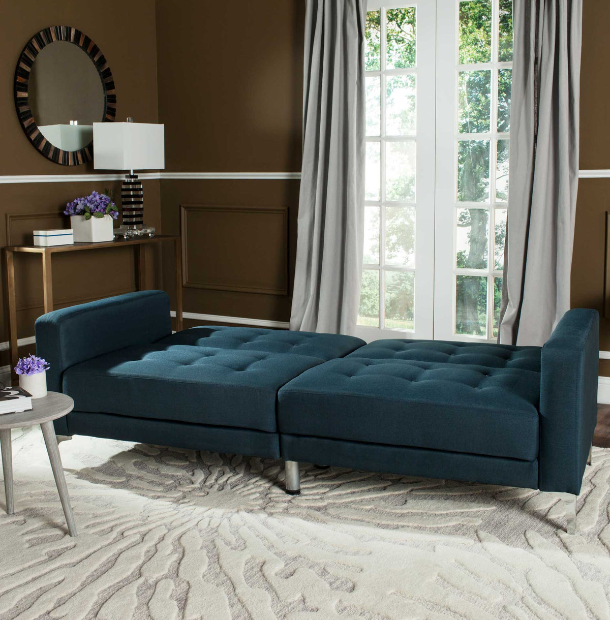 Tufted navy seats unfold into a broad bed with arms at either end.