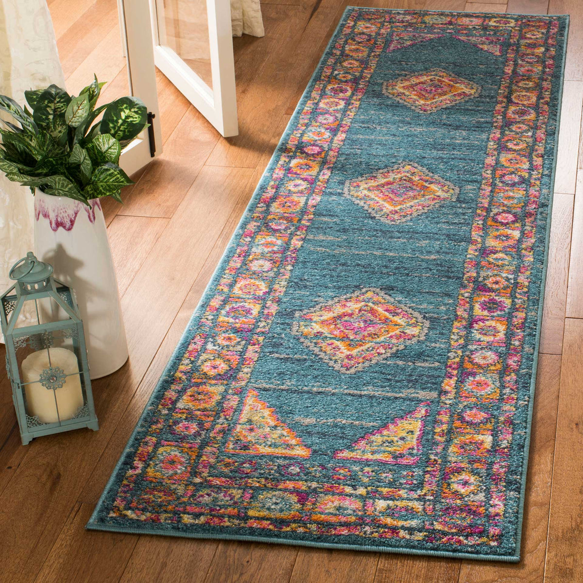 Light blue runner rug blends lively orange and pink details with a softly distressed finish