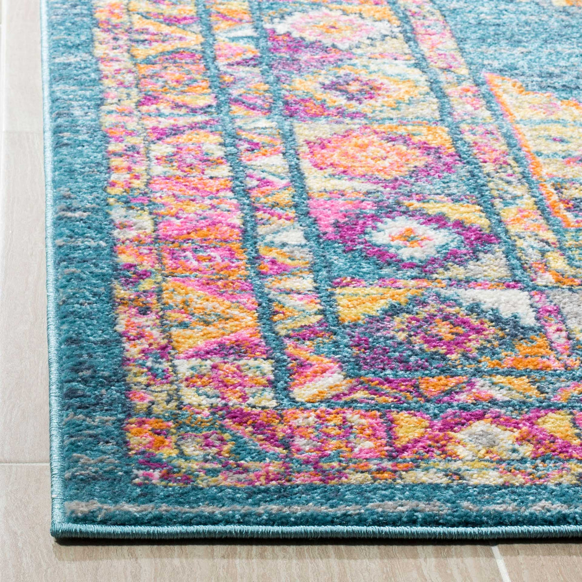 Soft light blue pile meets orange and pink floral motifs along a neatly bound edge