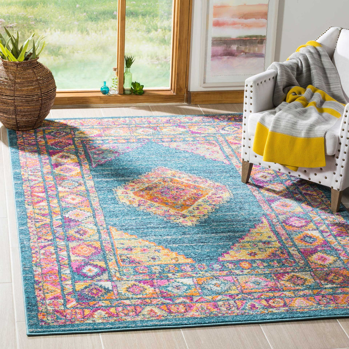 Light blue rug adds a radiant orange and pink diamond medallion to a welcoming living space