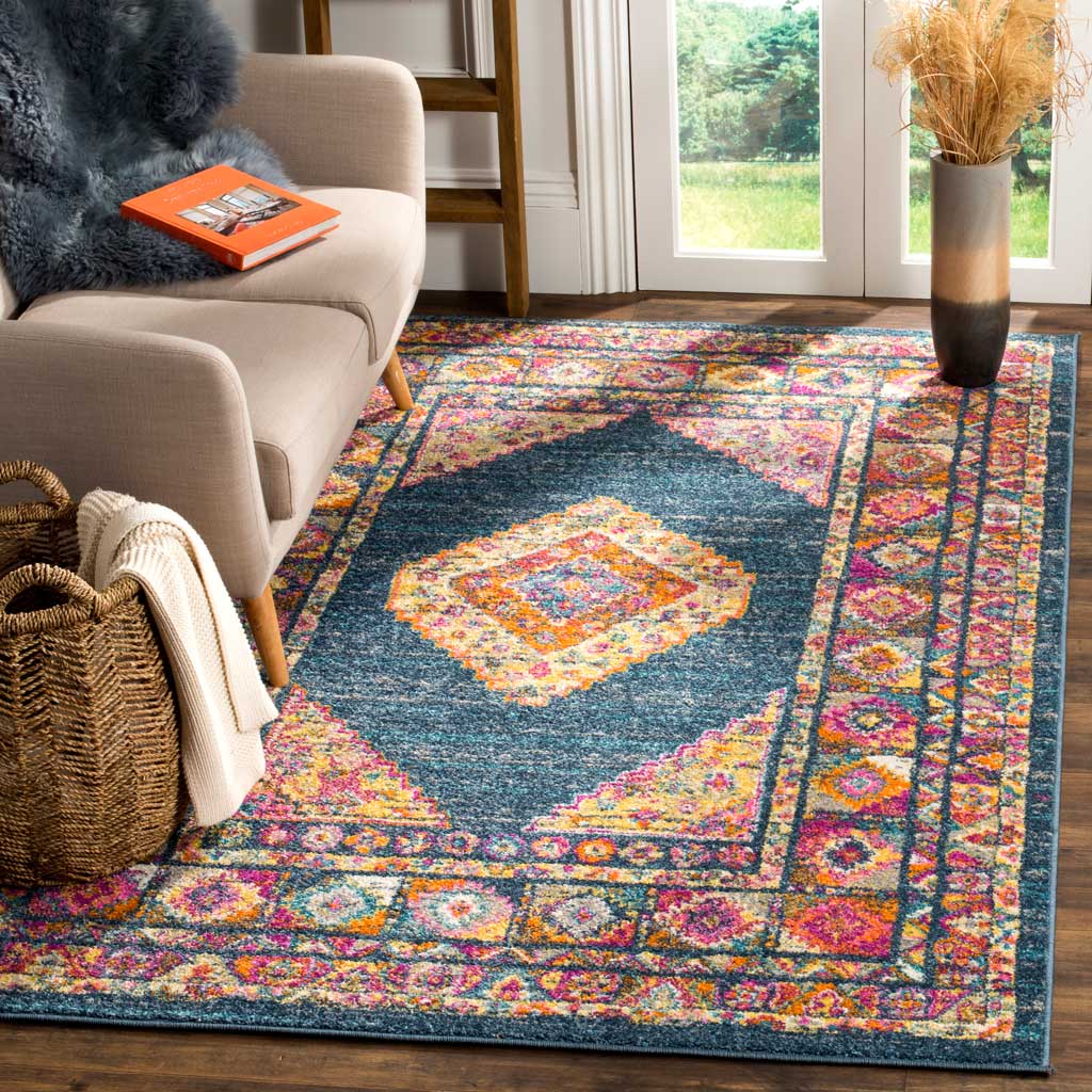 Vivid blue rug anchors a cozy room with its colorful medallion and patterned borders
