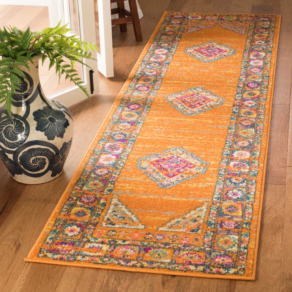 Bold orange runner rug pairs pink geometric accents with a richly detailed border