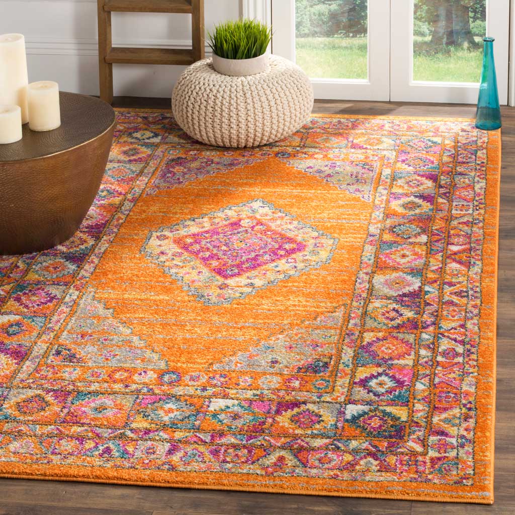 Bold orange rug brings a fuchsia medallion and ornate borders into a warm living space
