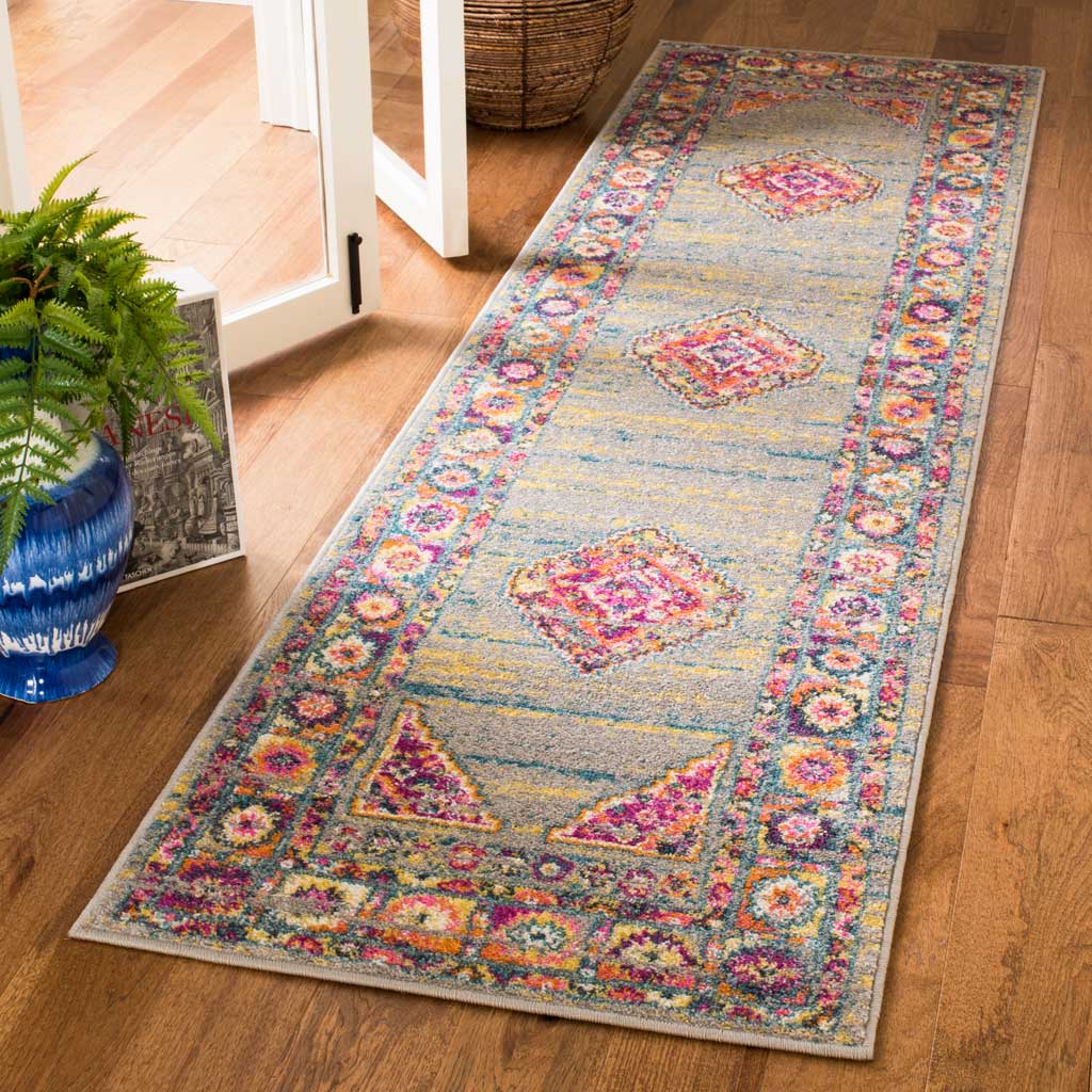 Soft gray ground sets off bright pink and orange geometric motifs on this runner rug