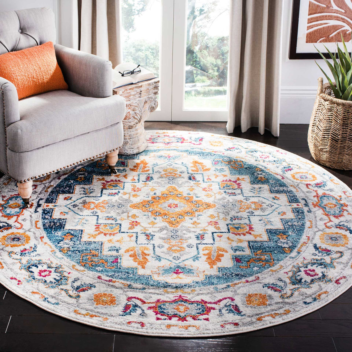 Colorful round rug brings an ornate medallion and floral border to a cozy living space