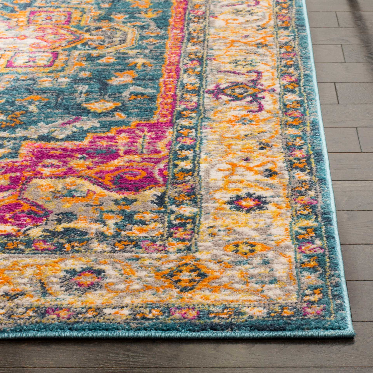Magenta and orange motifs enliven the blue field and ivory floral border, finished with a bound edge