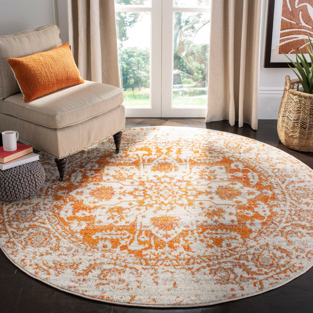 Warm orange motifs brighten this round ivory rug with lively traditional pattern