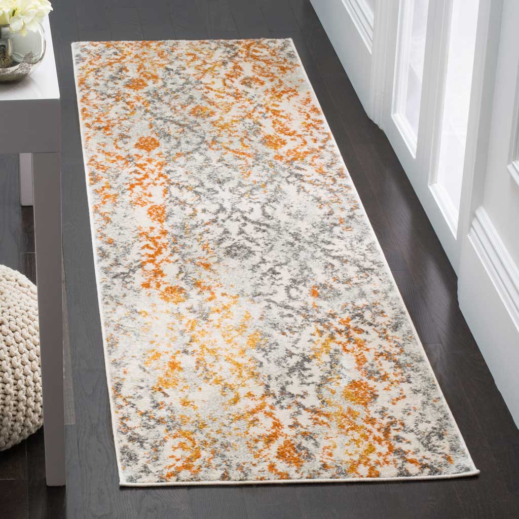 Orange and gray abstract accents enliven a cream runner on dark wood floors