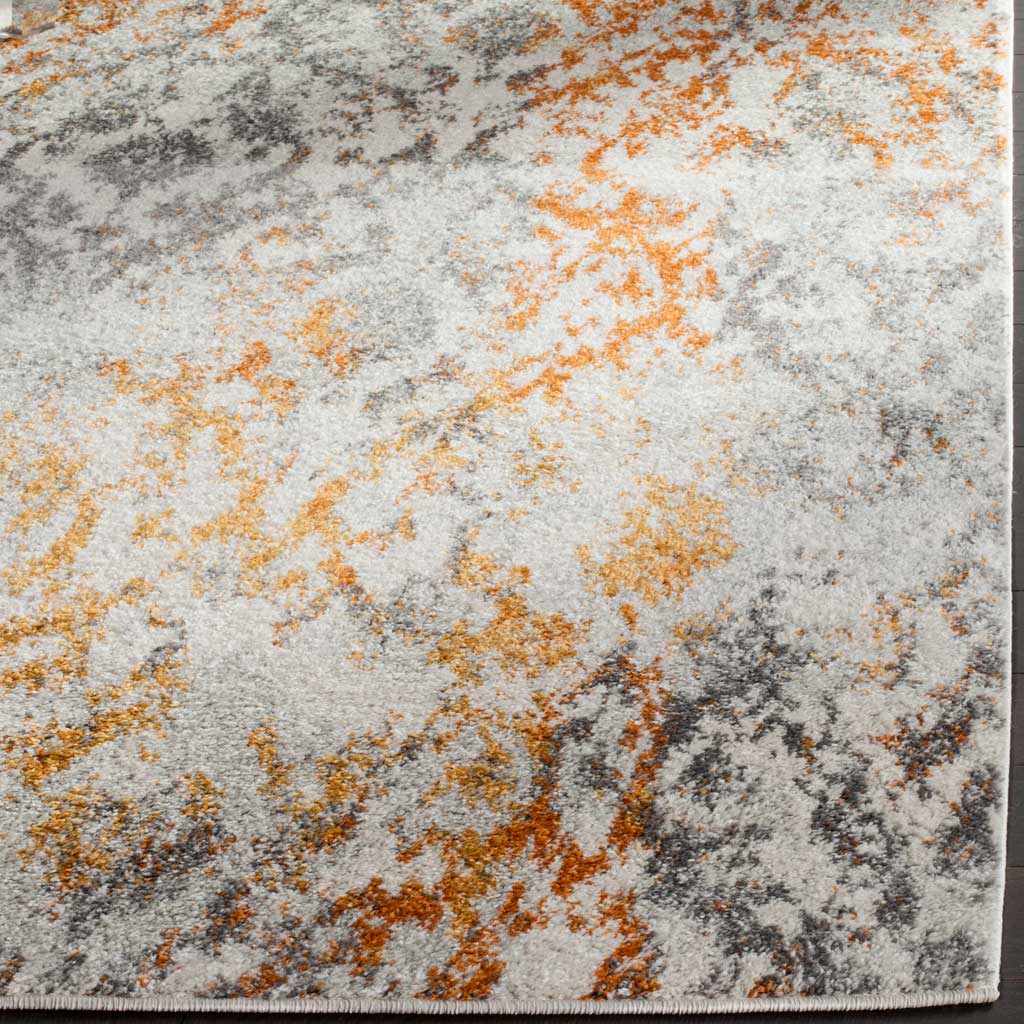 Mottled cream, orange, and gray pile meets a neatly bound edge