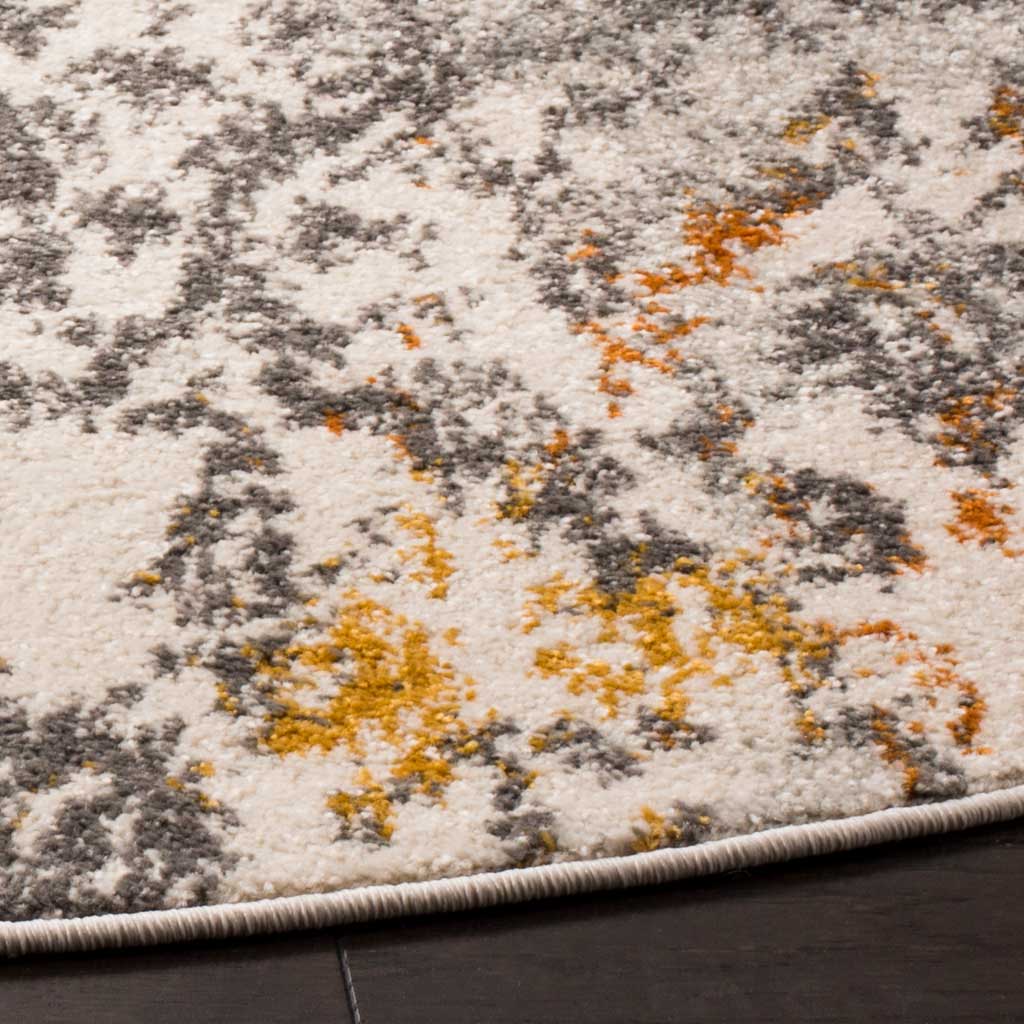 A neatly bound edge frames textured cream pile with orange and gray accents