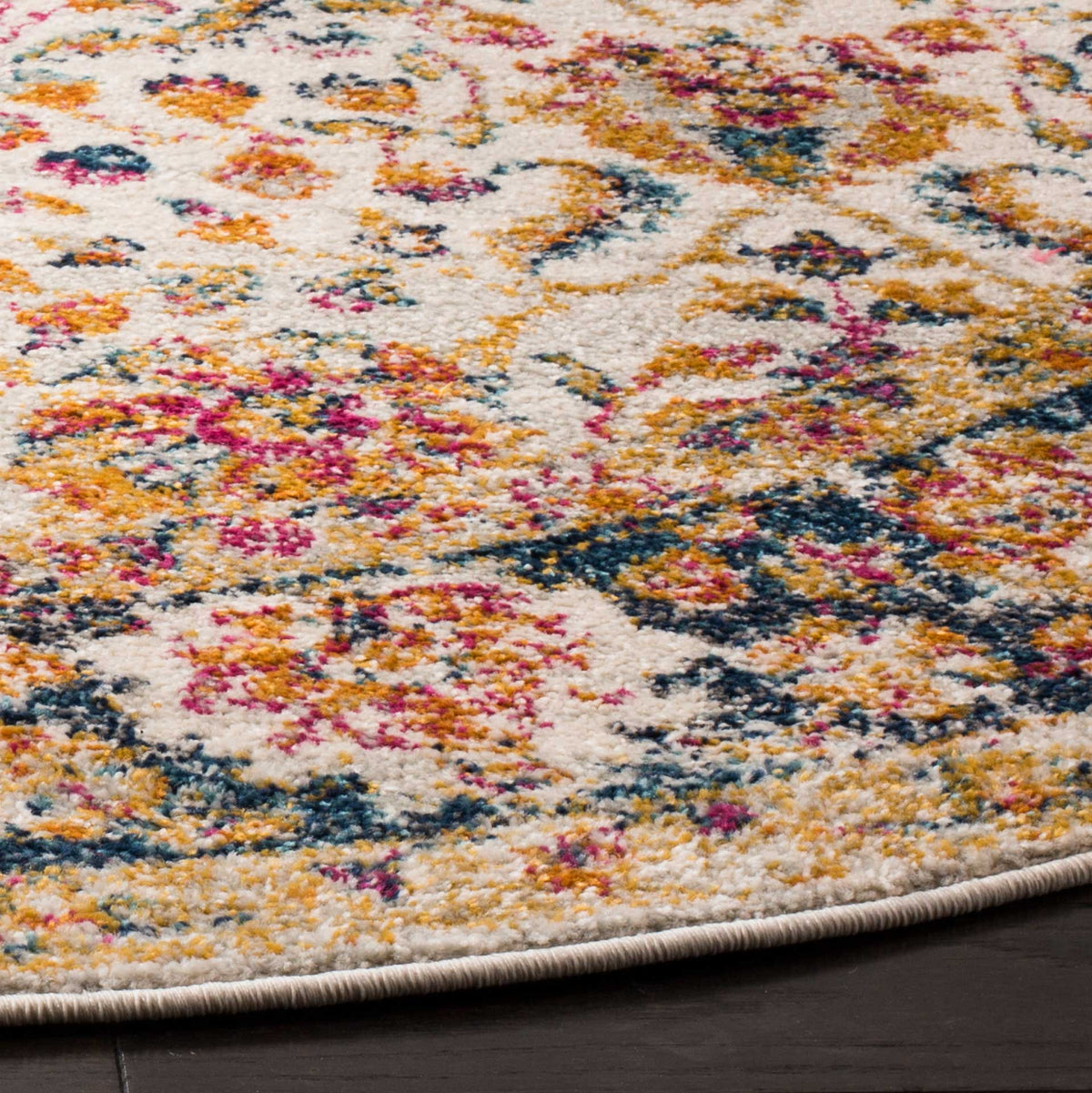 Colorful floral motifs on a cream pile meet a neatly bound edge