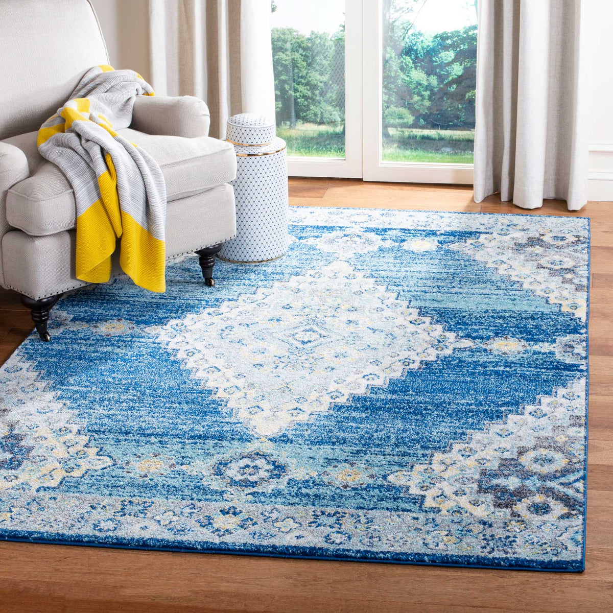 A distressed navy and cream medallion rug brings classic character to a bright living space.