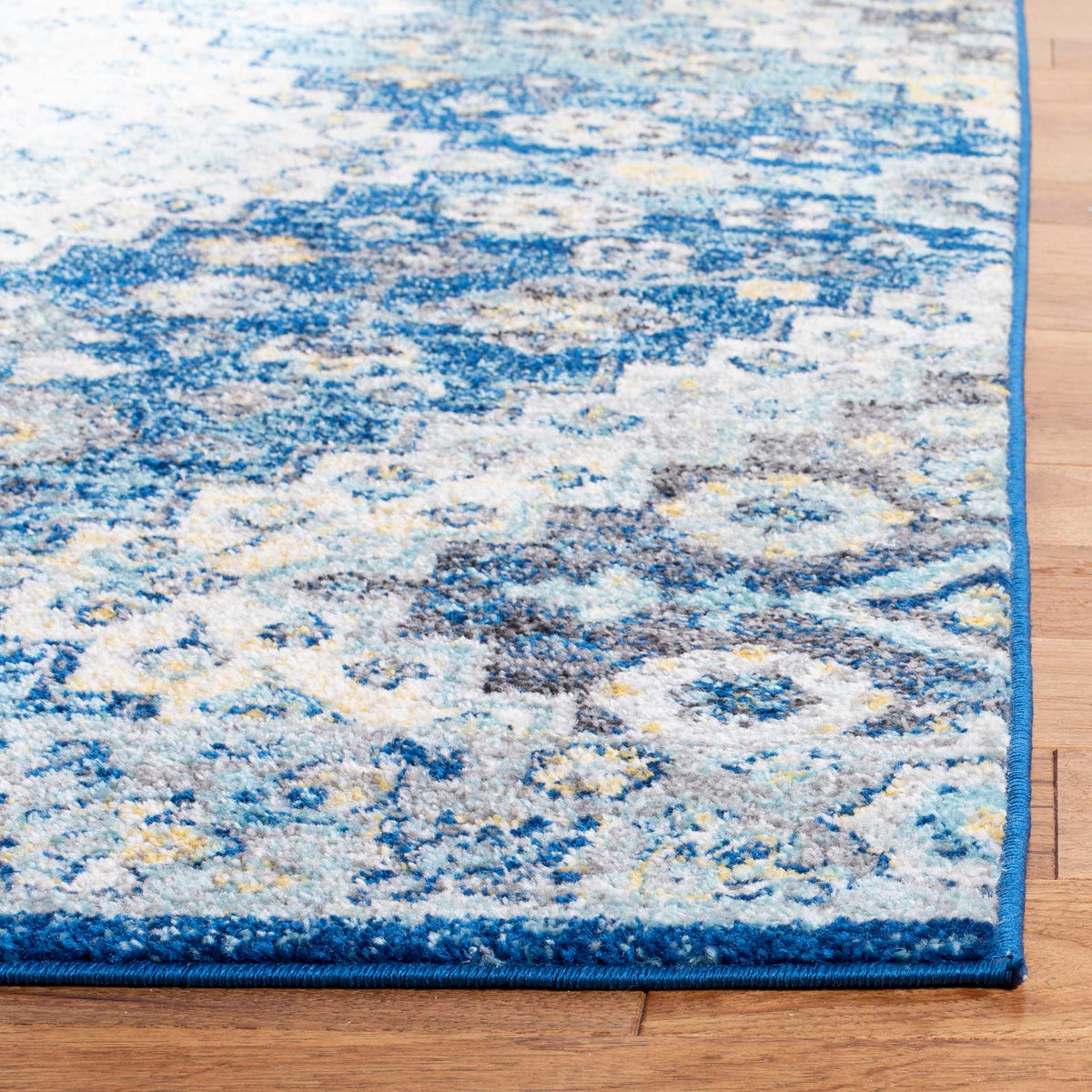 Blue and creme floral details meet a neatly bound navy edge