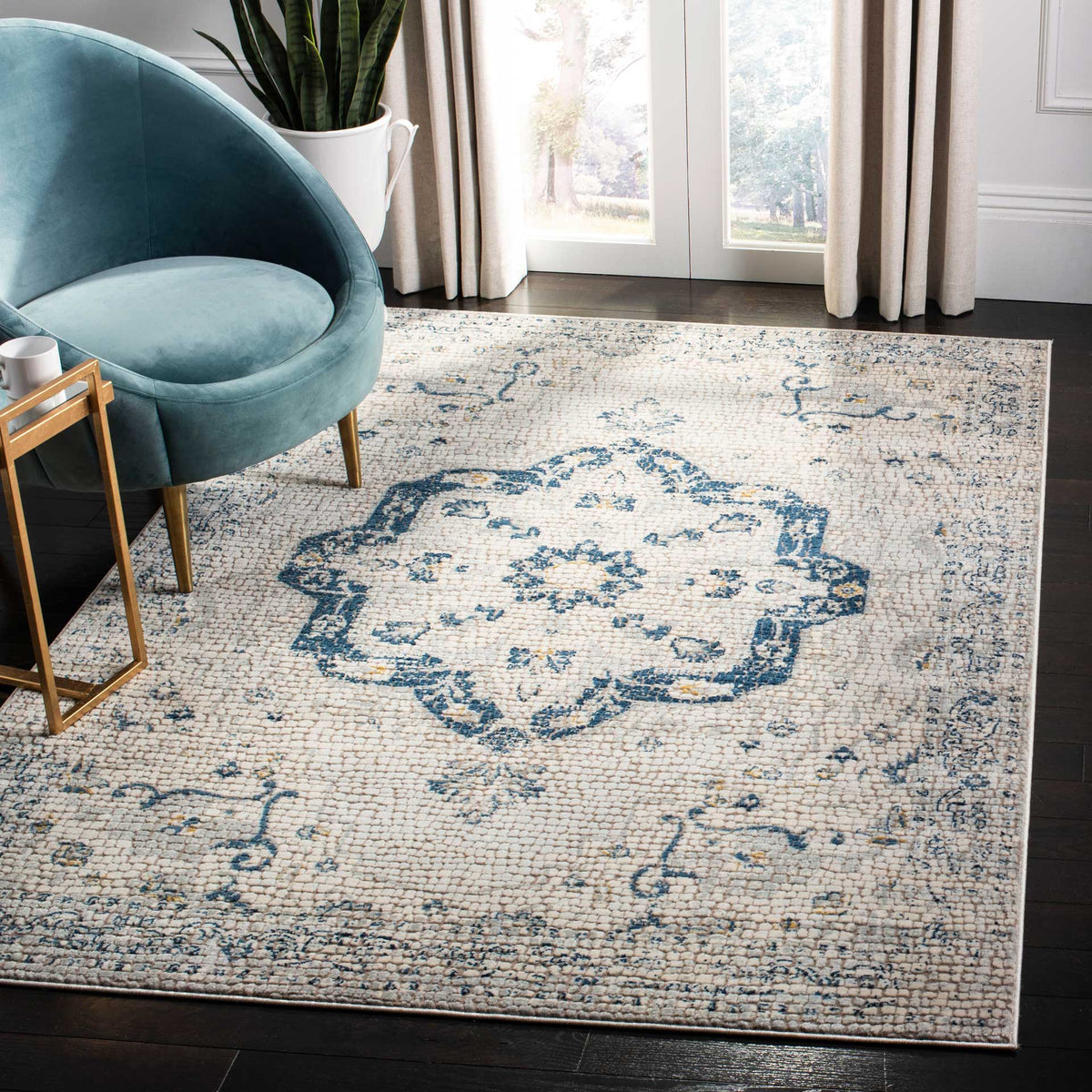 A navy medallion and softly distressed floral motifs bring vintage-inspired charm to this ivory rug