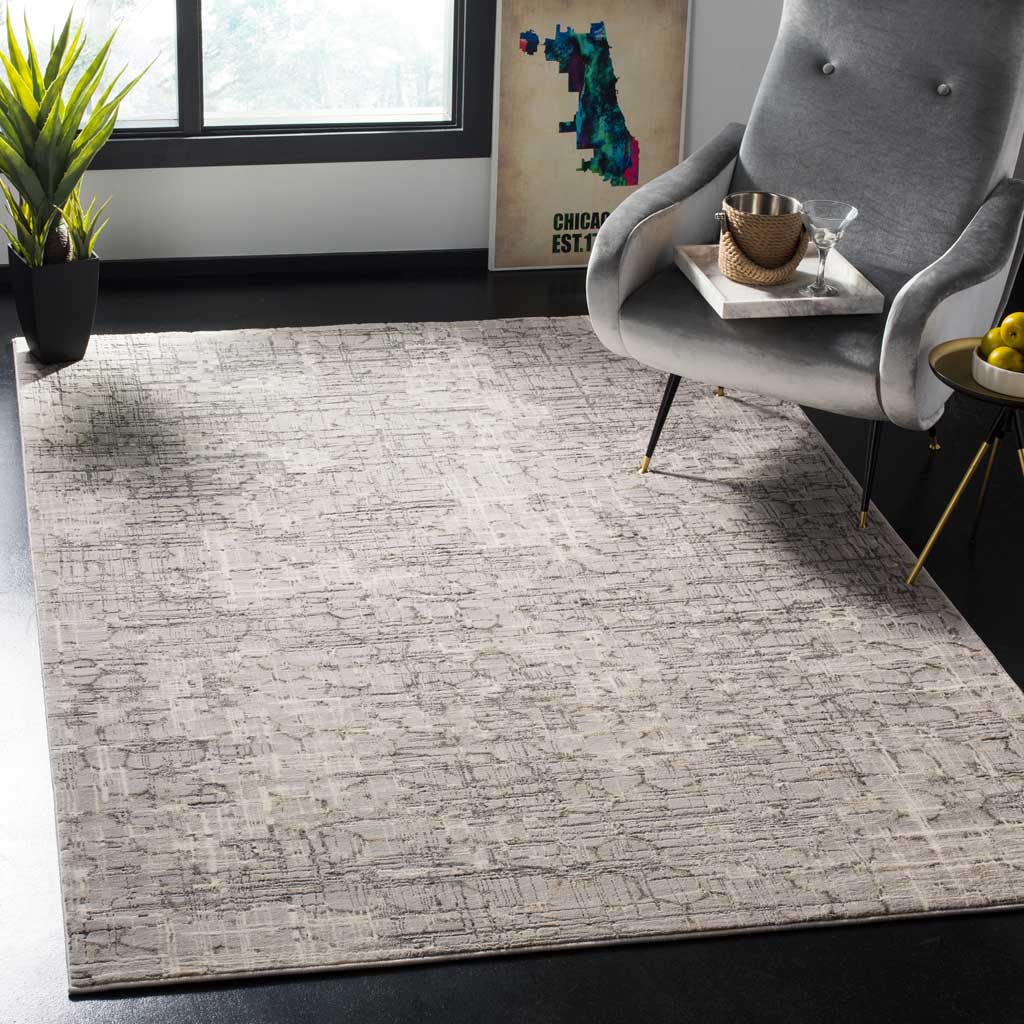 A gray abstract rug with layered, distressed lines adds texture to a contemporary seating area