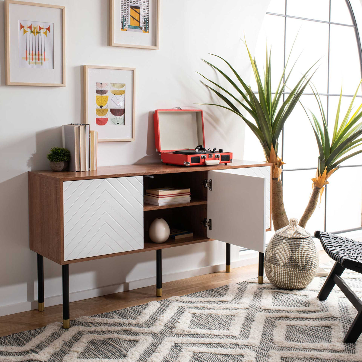 Open white doors reveal shelving for books beneath a wood-look top holding a record player