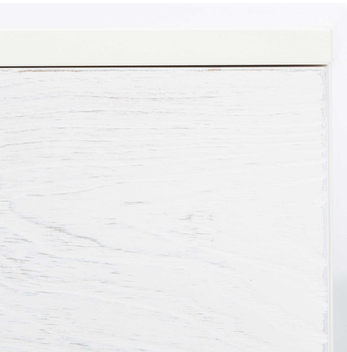 Pale whitewashed wood grain adds soft texture beneath the clean edge of the cream top.