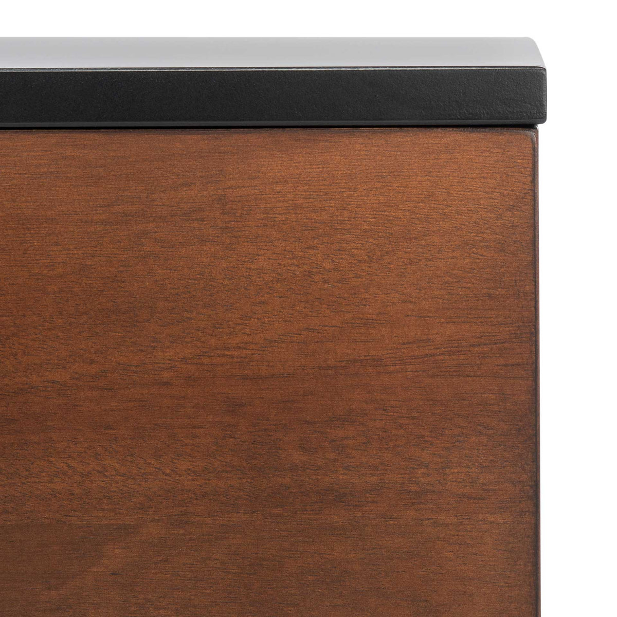 Rich walnut grain warms the cabinet front beneath the smooth edge of the black top.