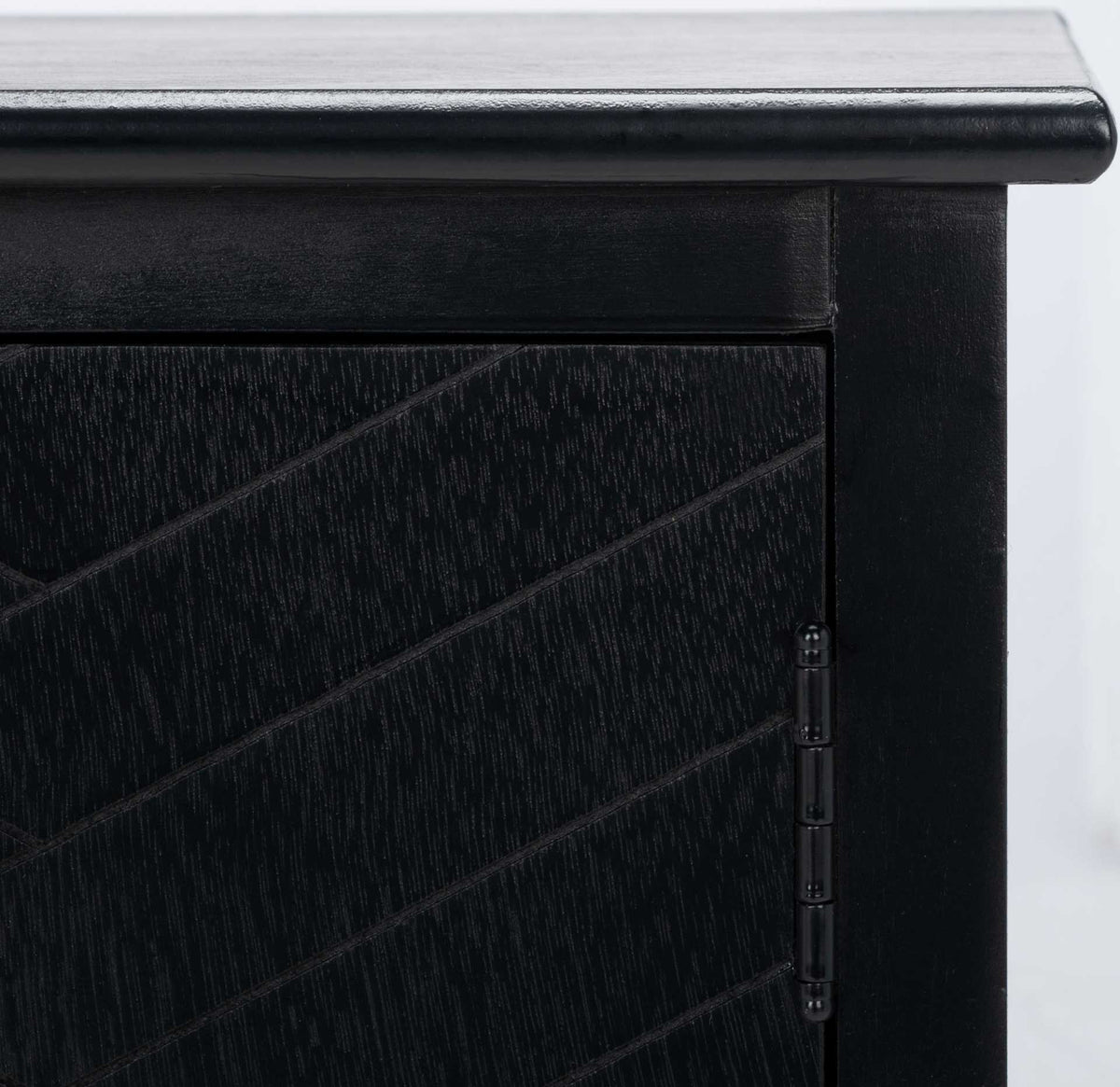 Subtle wood grain and diagonal door grooves meet a dark metal hinge on this black media stand.