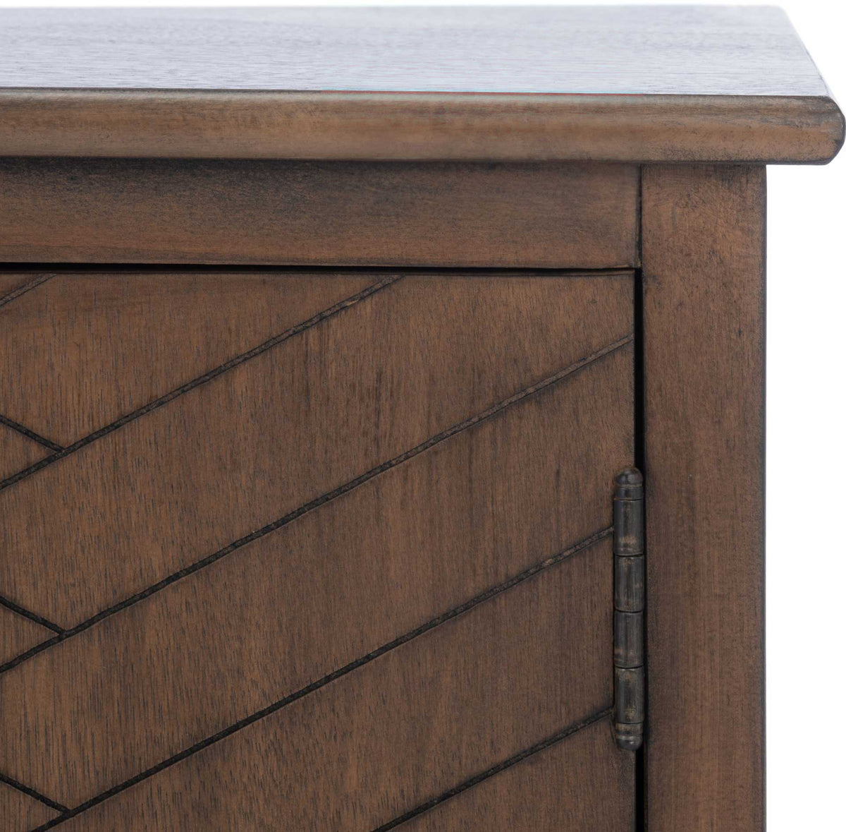 Engraved herringbone lines and a dark metal hinge enrich the brown cabinet door.