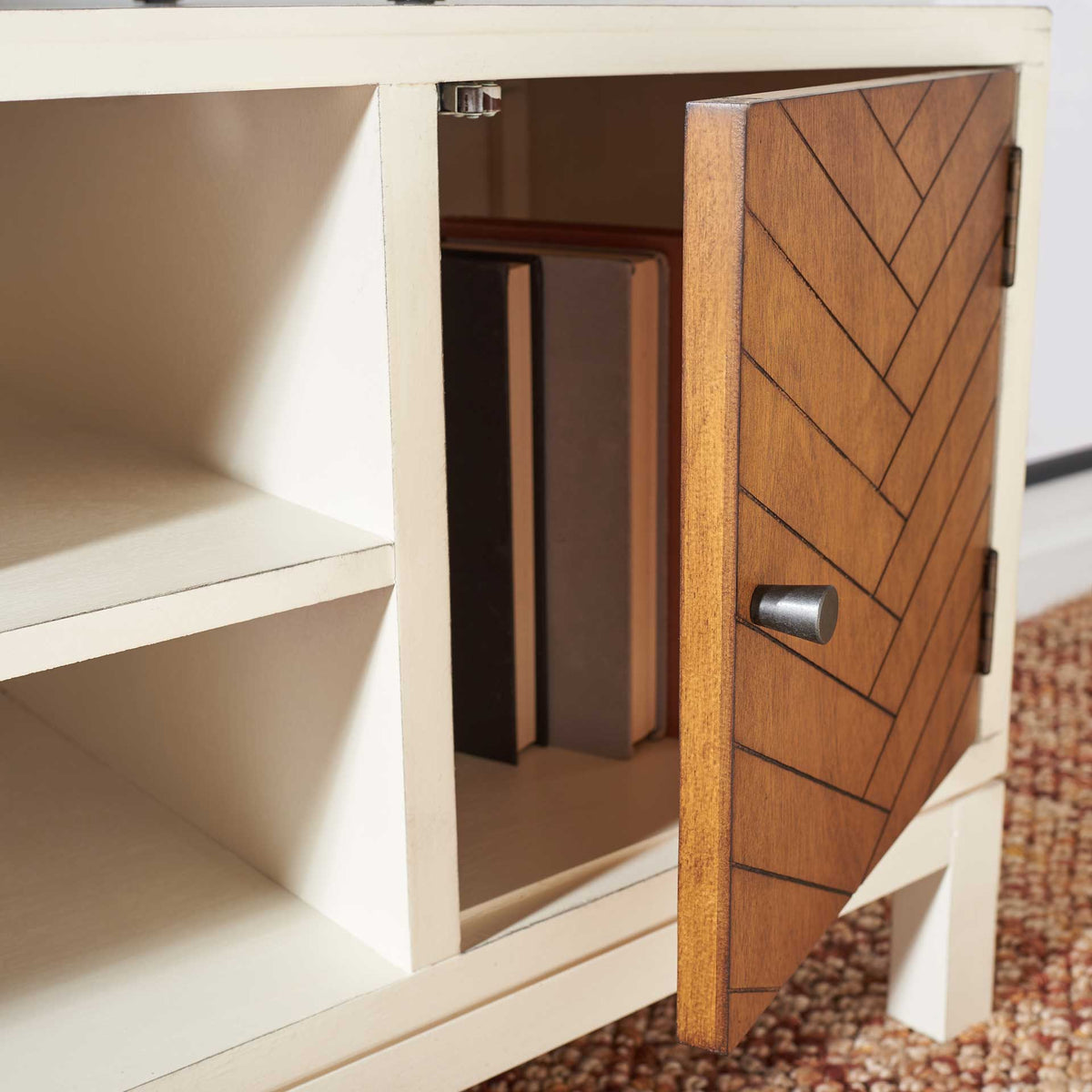An open honey brown door reveals space for books beside the white media shelves.