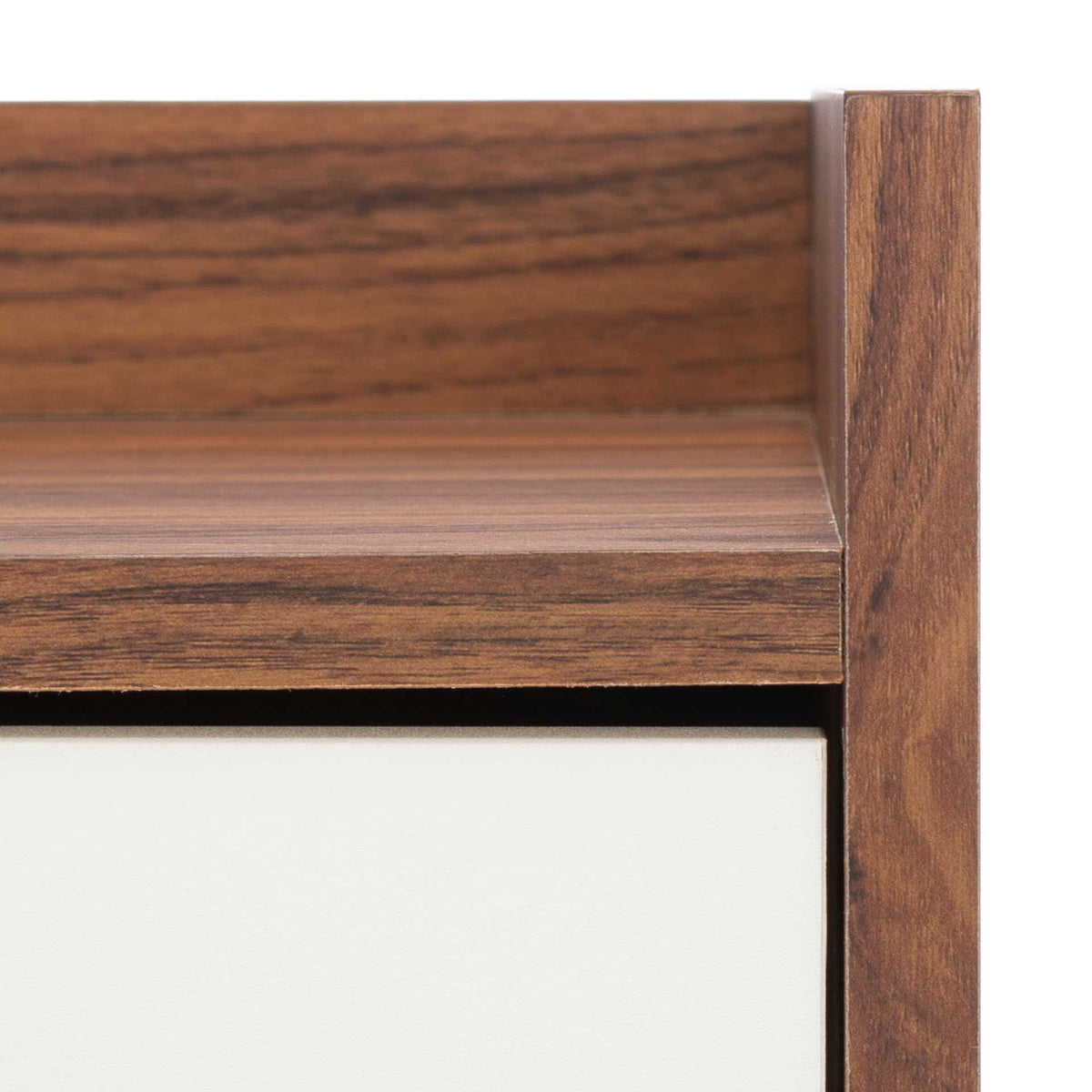 Walnut-finished grain and a raised top lip add warmth above the smooth white cabinet doors.